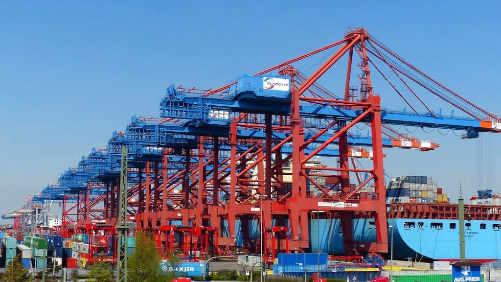 Container gantry cranes and a moored container ship at a port terminal